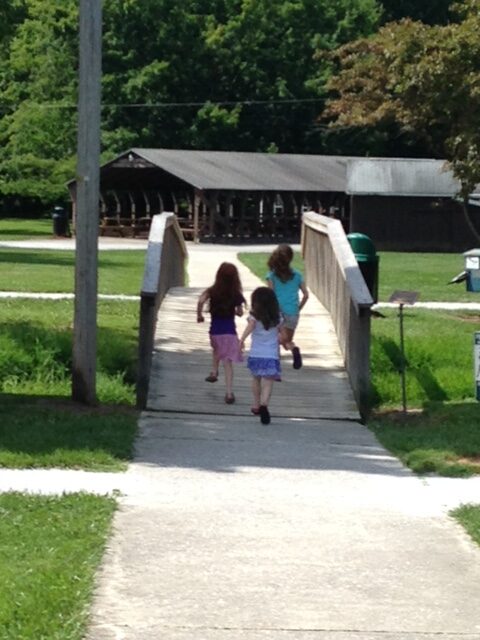 children running in a park setting