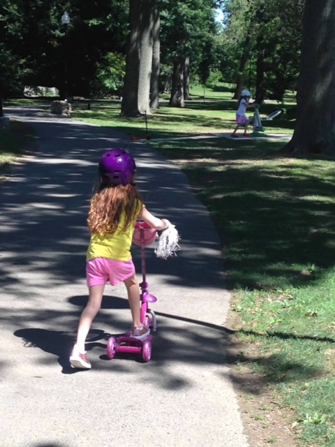 Child riding a scooter in a park can be part of your homeschool kindergarten