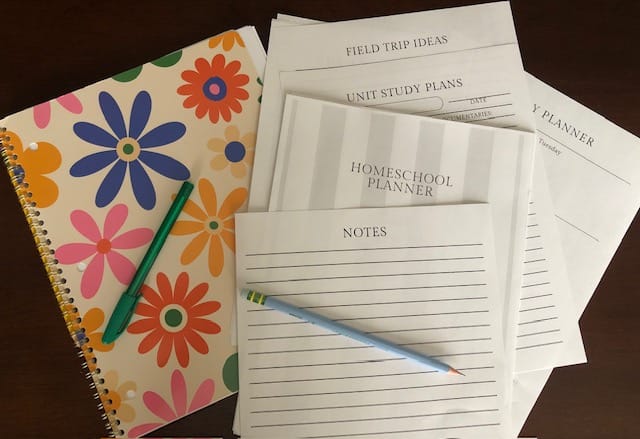Homeschool planner and spiral notebook with pen